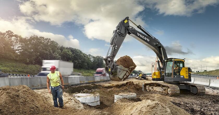 Volvo midsize excavator moving dirt on a major road building project.