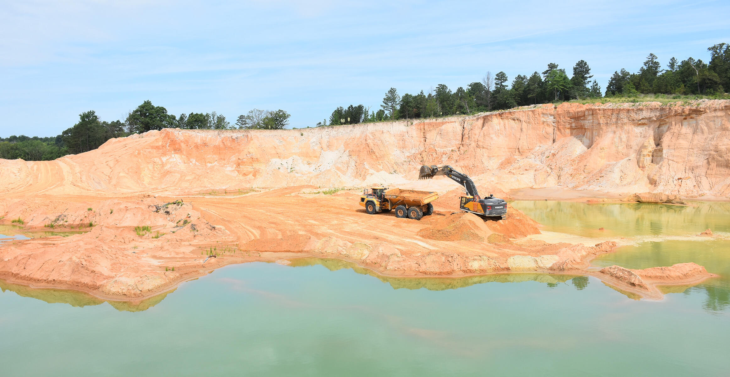 Volvo A60H Articulated Truck and EC750E Crawler Excavator at U.S. Silica quarry